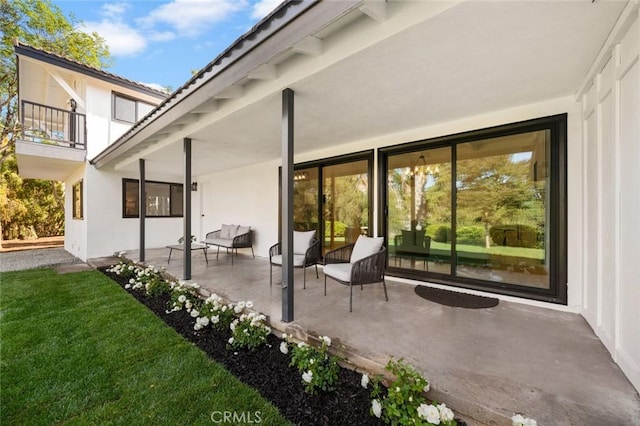 back of property with a yard, a patio area, and stucco siding