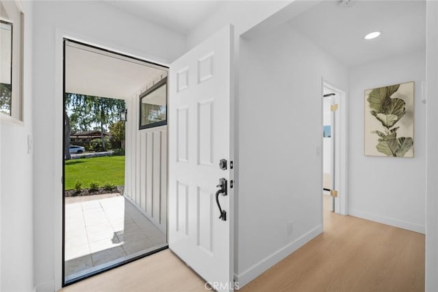 foyer entrance featuring baseboards, recessed lighting, and light wood finished floors