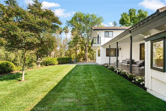view of yard featuring a patio area and a balcony