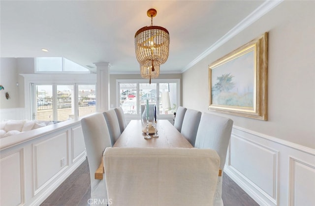 16143 Saint Croix Cir, Huntington Beach, CA 92649 - dining space featuring a decorative wall, crown molding, a chandelier, wainscoting, and decorative columns