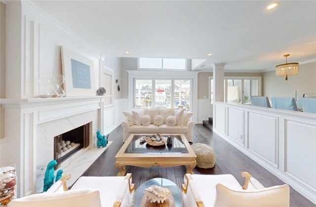 16143 Saint Croix Cir, Huntington Beach, CA 92649 - living room featuring a decorative wall, wainscoting, wood finished floors, a fireplace, and recessed lighting