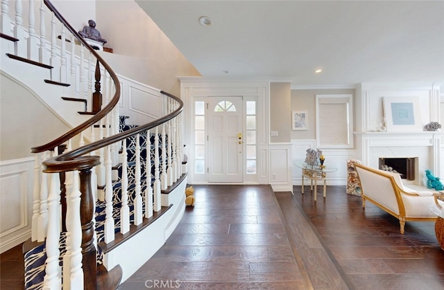 16143 Saint Croix Cir, Huntington Beach, CA 92649 - entrance foyer featuring a decorative wall, stairway, crown molding, wainscoting, and a premium fireplace