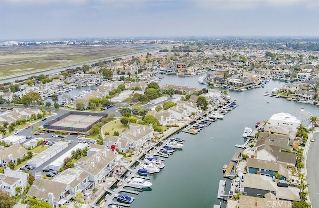 view of property location featuring a nearby body of water and nearby suburban area