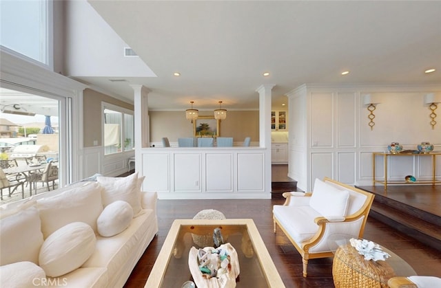 16143 Saint Croix Cir, Huntington Beach, CA 92649 - living room with decorative columns, a decorative wall, dark wood finished floors, ornamental molding, and recessed lighting