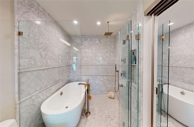16143 Saint Croix Cir, Huntington Beach, CA 92649 - full bathroom with tile walls, a shower stall, a soaking tub, and recessed lighting