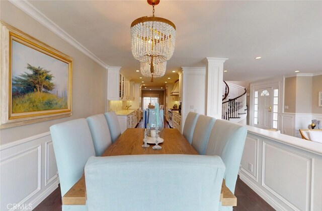 16143 Saint Croix Cir, Huntington Beach, CA 92649 - dining area featuring a decorative wall, healthy amount of natural light, a chandelier, stairway, and dark wood-style floors