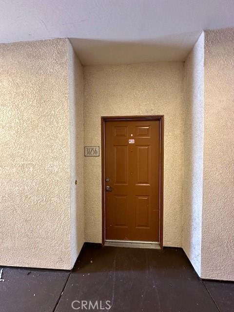 entrance to property with stucco siding