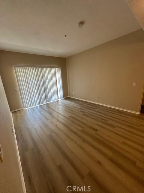 interior space with baseboards and wood finished floors