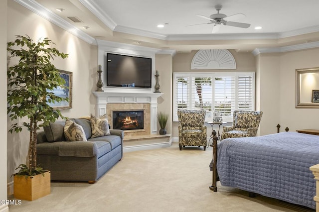 bedroom with a premium fireplace, carpet floors, crown molding, visible vents, and a raised ceiling
