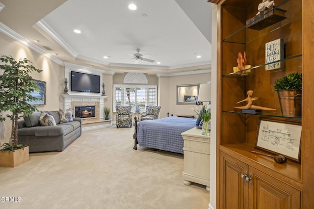 bedroom featuring crown molding, a raised ceiling, a high end fireplace, light colored carpet, and recessed lighting