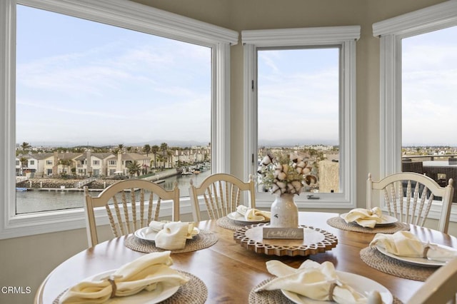 dining area with a water view and wood finished floors