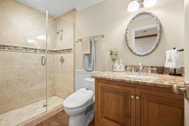 full bathroom with toilet, vanity, wood finished floors, and a stall shower