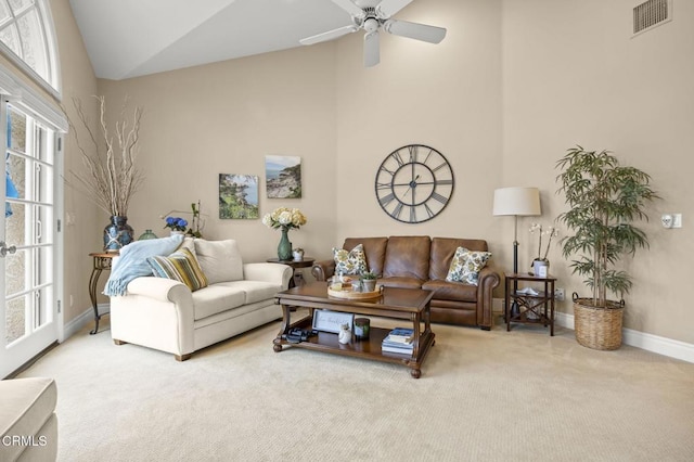 living area featuring carpet flooring, plenty of natural light, visible vents, and baseboards
