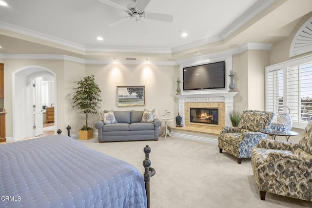 bedroom featuring ornamental molding, recessed lighting, a fireplace, carpet flooring, and arched walkways
