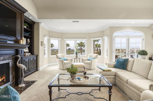 living room with a premium fireplace, baseboards, visible vents, and recessed lighting