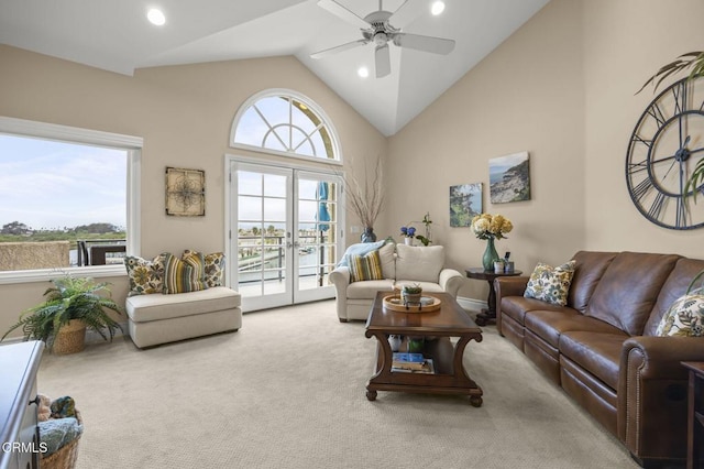 carpeted living area with a ceiling fan, recessed lighting, and high vaulted ceiling