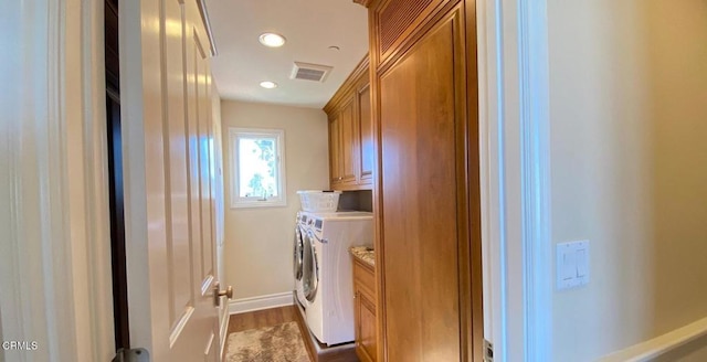 laundry room featuring cabinet space, recessed lighting, washer and clothes dryer, visible vents, and dark wood-style floors