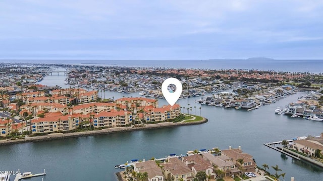 drone / aerial view featuring a water view and a residential view
