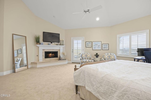 bedroom featuring baseboards, a warm lit fireplace, light carpet, and access to exterior