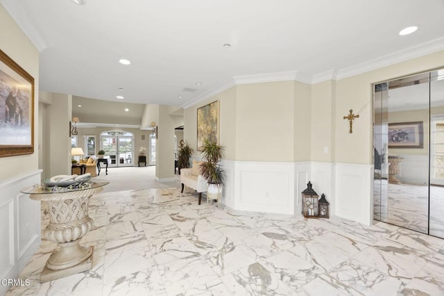 interior space featuring a wainscoted wall, a decorative wall, ornamental molding, and recessed lighting