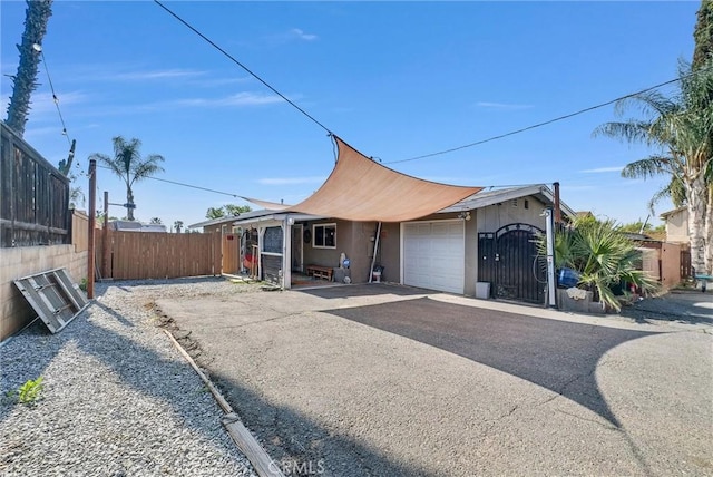 24 S La Salle St, Redlands, CA 92374 - ranch-style house featuring stucco siding, a garage, aphalt driveway, and fence