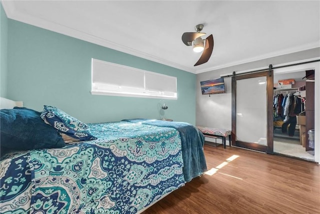 24 S La Salle St, Redlands, CA 92374 - bedroom with crown molding, a closet, wood finished floors, a barn door, and a ceiling fan