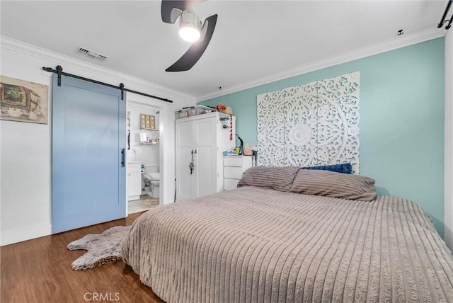 24 S La Salle St, Redlands, CA 92374 - bedroom featuring wood finished floors, ornamental molding, a barn door, and visible vents