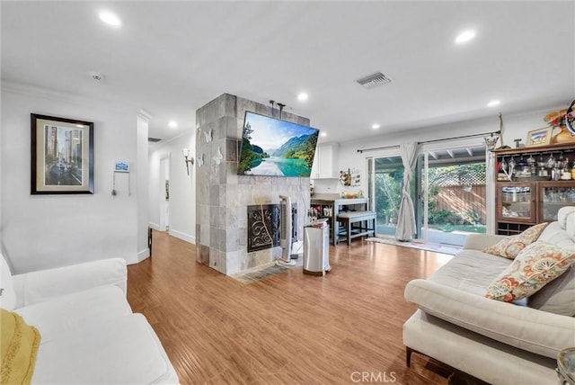 24 S La Salle St, Redlands, CA 92374 - living area with visible vents, recessed lighting, a tiled fireplace, and wood finished floors