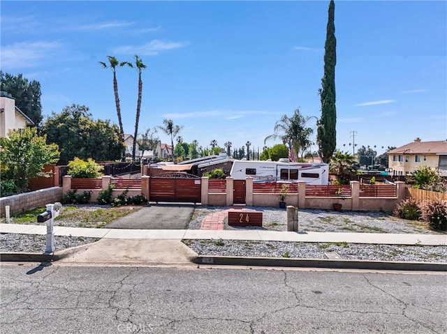 24 S La Salle St, Redlands, CA 92374 - mid-century home featuring a fenced front yard, a gate, and aphalt driveway