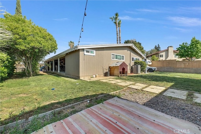 24 S La Salle St, Redlands, CA 92374 - rear view of property with a lawn, fence, and central air condition unit