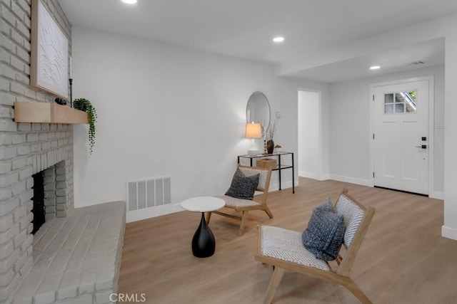 413 N Rimhurst Ave, Covina, CA 91724 - sitting room with a fireplace, recessed lighting, baseboards, wood finished floors, and visible vents