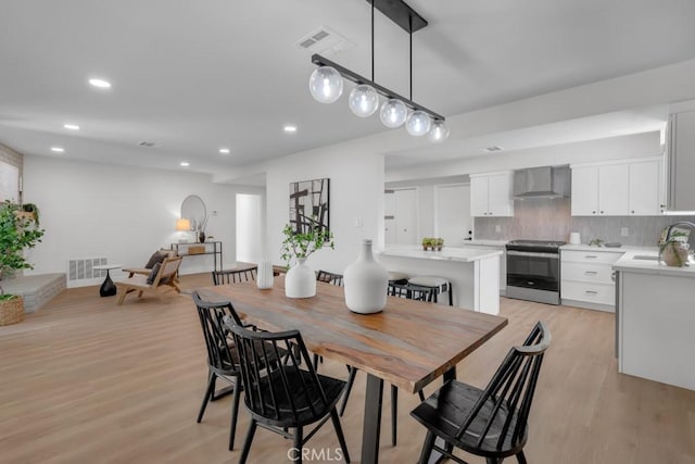 413 N Rimhurst Ave, Covina, CA 91724 - dining area with light wood-style floors, recessed lighting, and visible vents