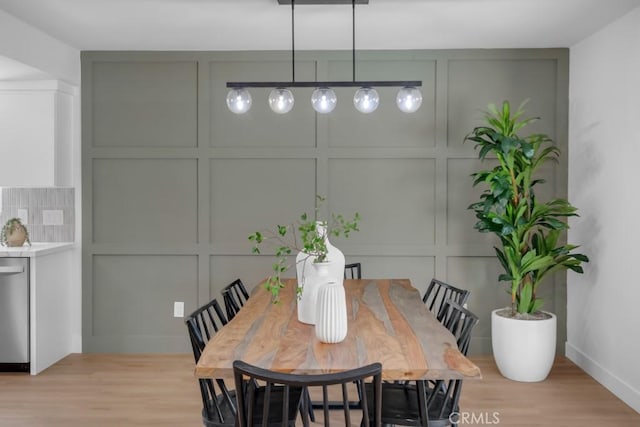 413 N Rimhurst Ave, Covina, CA 91724 - dining space with baseboards, light wood-style flooring, and a decorative wall