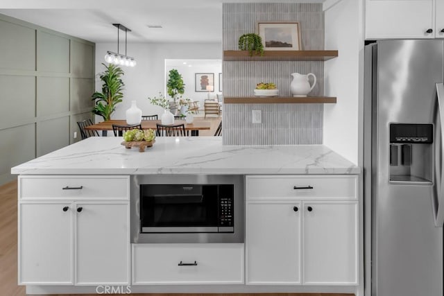 413 N Rimhurst Ave, Covina, CA 91724 - kitchen with open shelves, light stone countertops, stainless steel fridge with ice dispenser, built in microwave, and white cabinetry