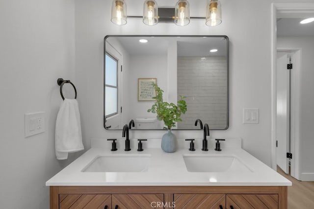 413 N Rimhurst Ave, Covina, CA 91724 - bathroom featuring double vanity, a sink, and wood finished floors