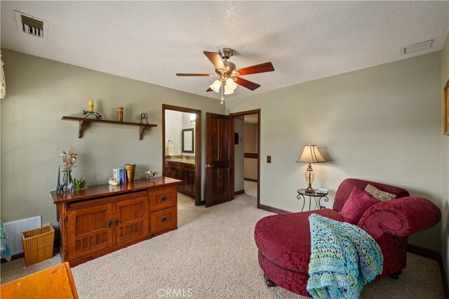 sitting room featuring baseboards, ceiling fan, light carpet, and visible vents