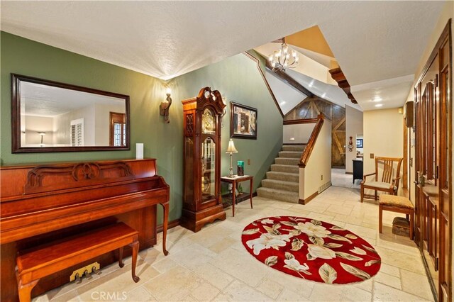 interior space featuring baseboards, stairs, a textured ceiling, and stone tile floors