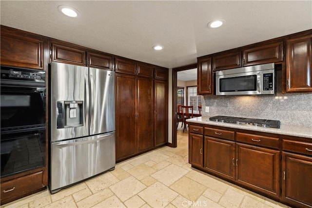 kitchen featuring recessed lighting, light countertops, decorative backsplash, and appliances with stainless steel finishes
