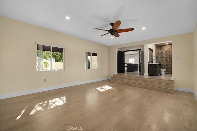405 E Colton Ave, Redlands, CA 92374 - unfurnished living room with ceiling fan, a wood stove, light wood-type flooring, baseboards, and recessed lighting