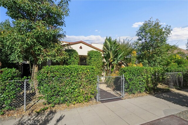 405 E Colton Ave, Redlands, CA 92374 - view of front of house with stucco siding, a gate, and fence