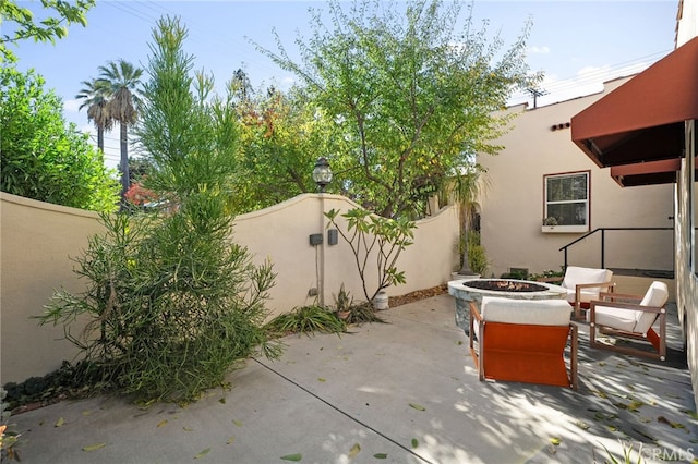 405 E Colton Ave, Redlands, CA 92374 - view of patio / terrace featuring an outdoor fire pit and fence