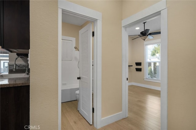 405 E Colton Ave, Redlands, CA 92374 - hall featuring baseboards, a sink, and light wood-style floors