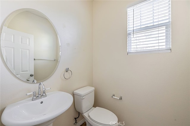 bathroom with toilet and a sink