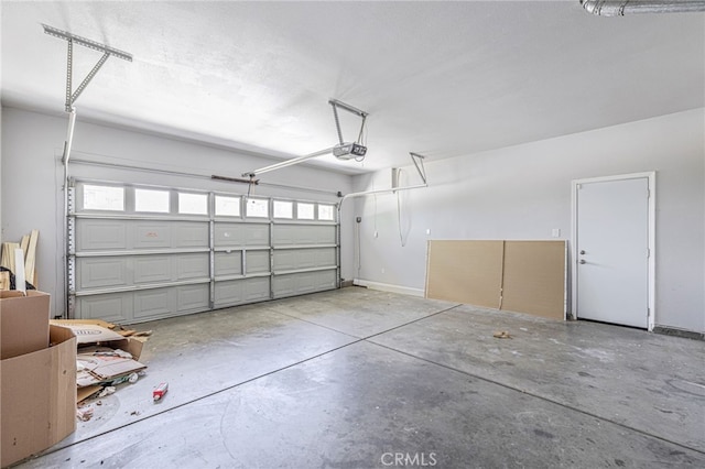 garage featuring baseboards and a garage door opener