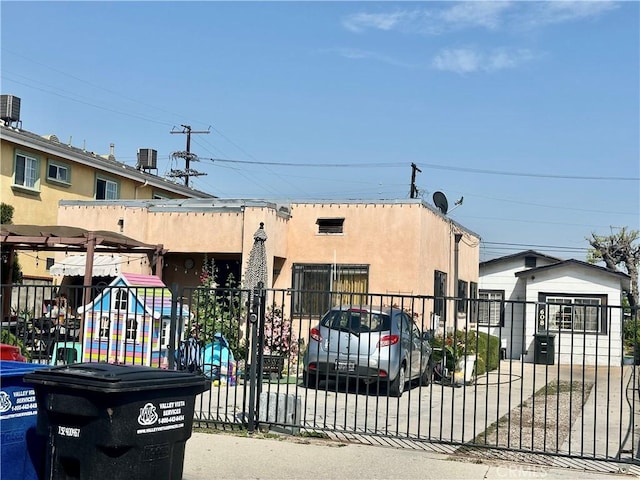 view of gate with fence and central AC unit