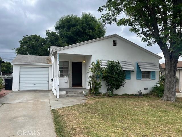 5548 Carley Ave, Whittier, CA 90601 - view of front of house with a front yard, a garage, stucco siding, and concrete driveway
