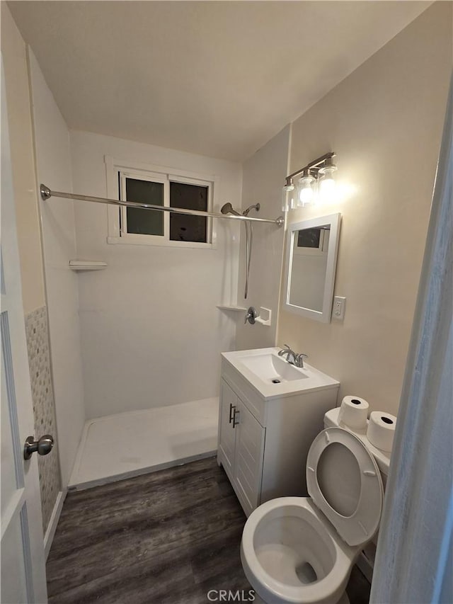 9412 Haney St, Pico Rivera, CA 90660 - full bath featuring toilet, tiled shower, wood finished floors, and vanity