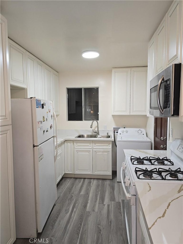 9412 Haney St, Pico Rivera, CA 90660 - kitchen featuring white appliances, a sink, washer / dryer, white cabinetry, and wood finished floors