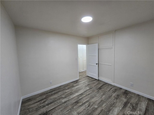 9412 Haney St, Pico Rivera, CA 90660 - unfurnished bedroom with dark wood-style floors and baseboards