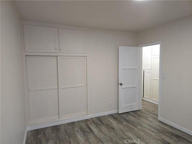 9412 Haney St, Pico Rivera, CA 90660 - unfurnished bedroom featuring baseboards, dark wood finished floors, and a closet